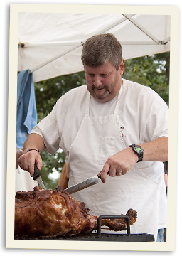 Roasting a pig for visiting missionaries Carving a pig